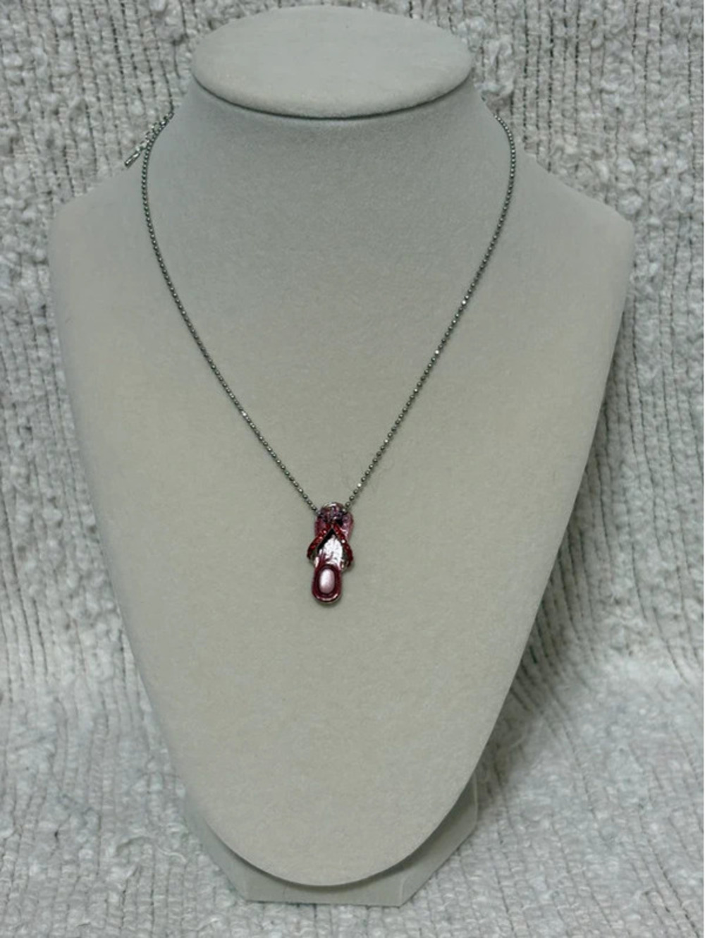 silver-tone chain necklace with small red enamel flip-flop pendant